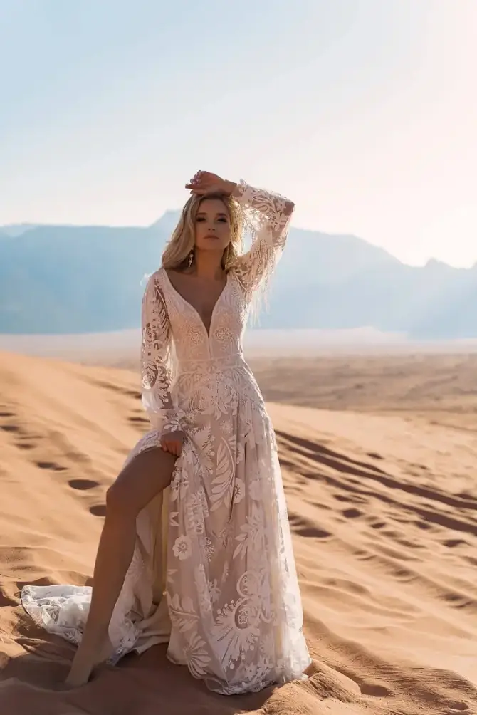 model is wearing a long sleeve bohemian bridal gown