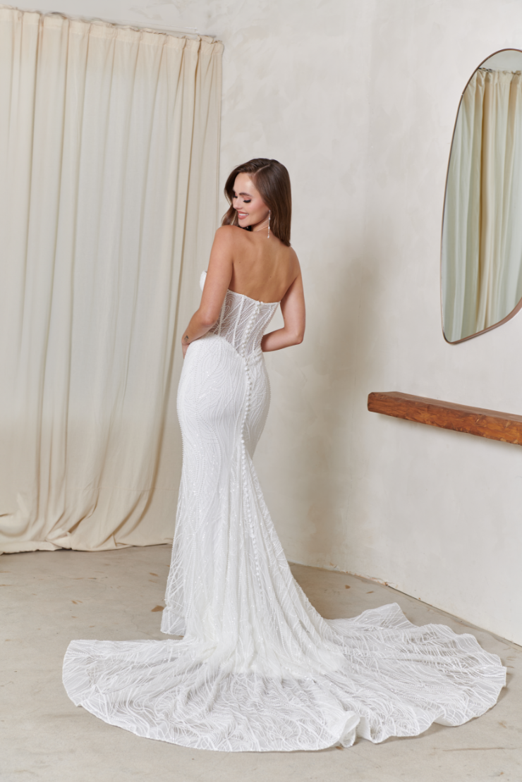 model is wearing a strapless fitted bridal gown