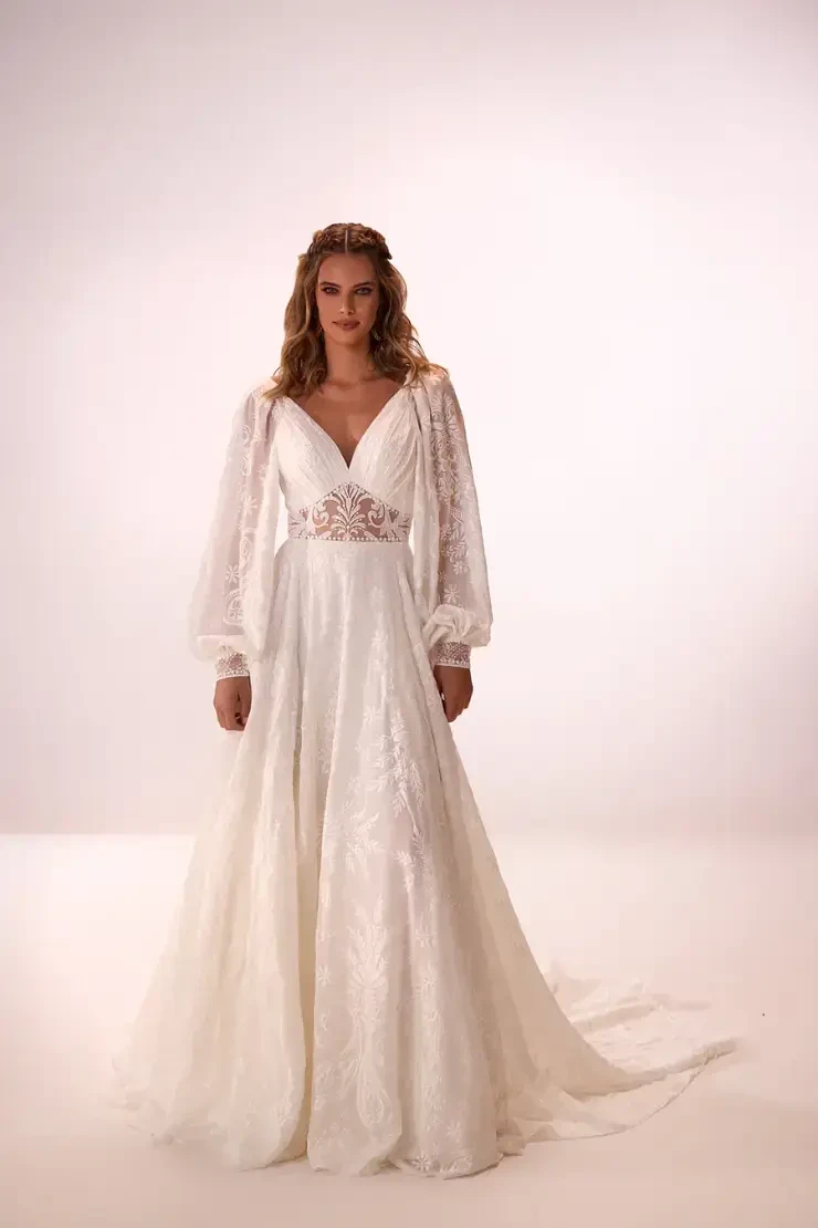model is wearing a long sleeve boho bridal gown