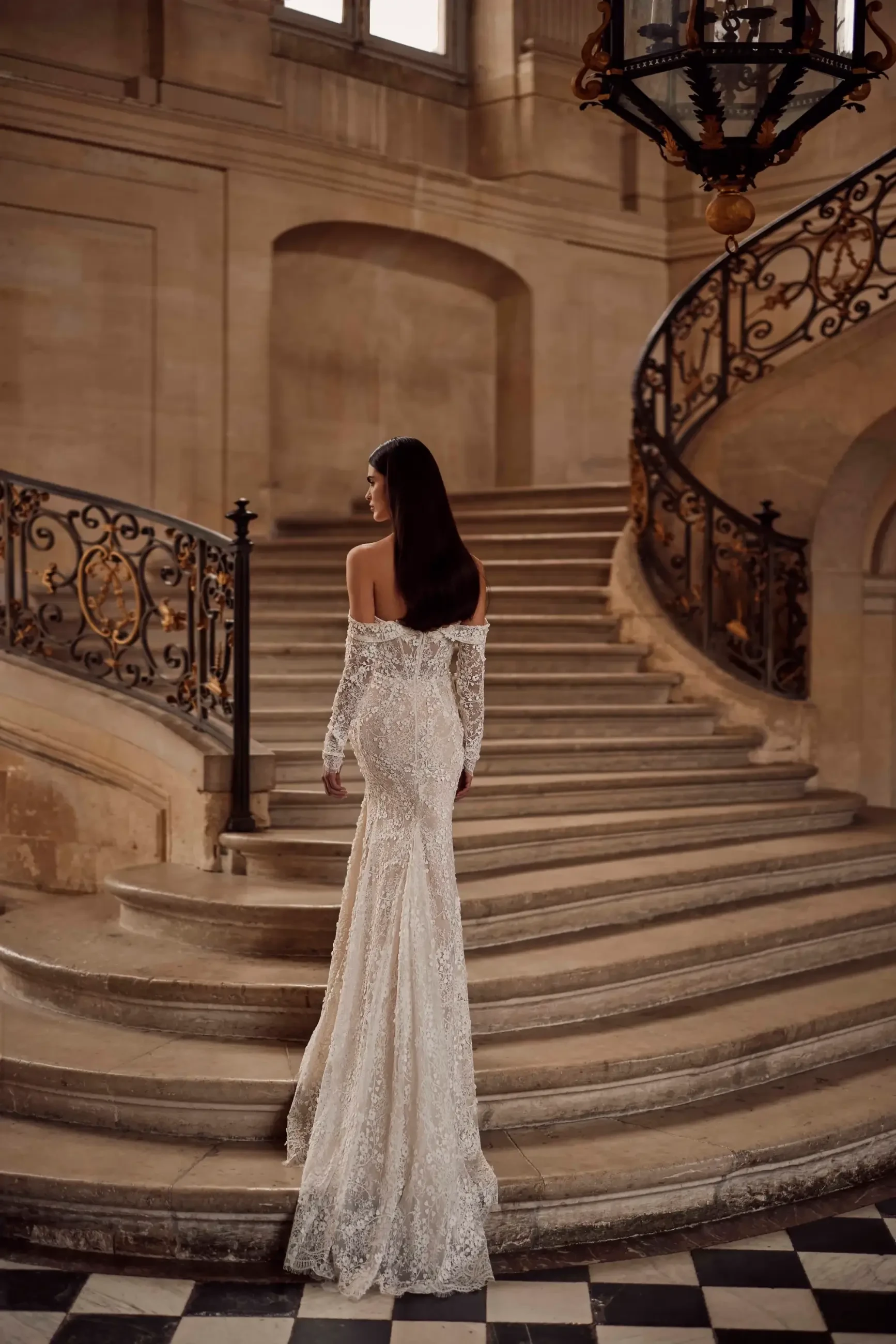 model is wearing an off the shoulder fit and flare wedding dress