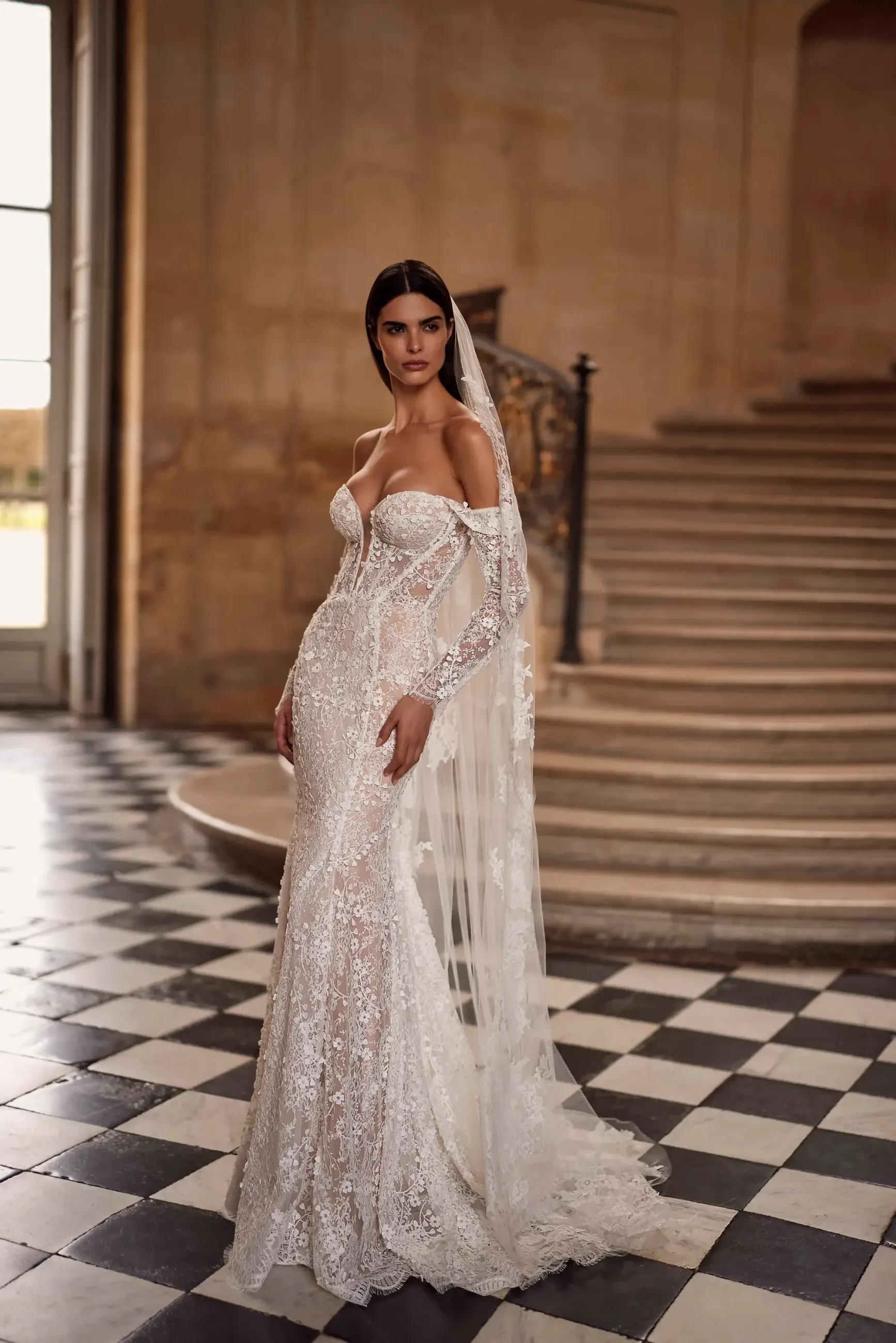 model is wearing an off the shoulder fit and flare wedding dress