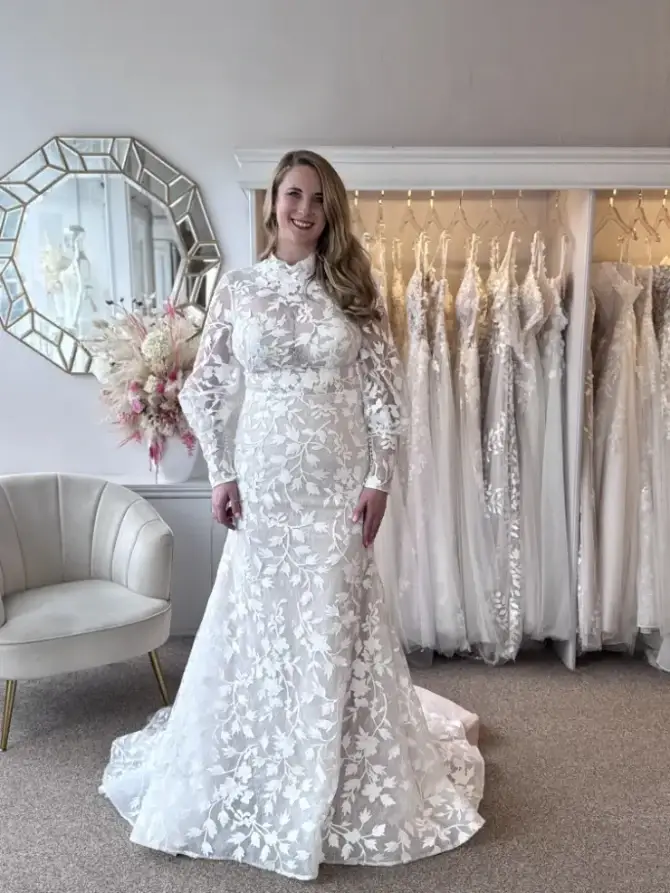 model wearing a high neck long sleeve lace wedding gown