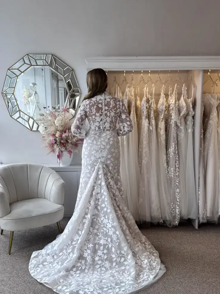 model wearing a high neck long sleeve lace wedding gown